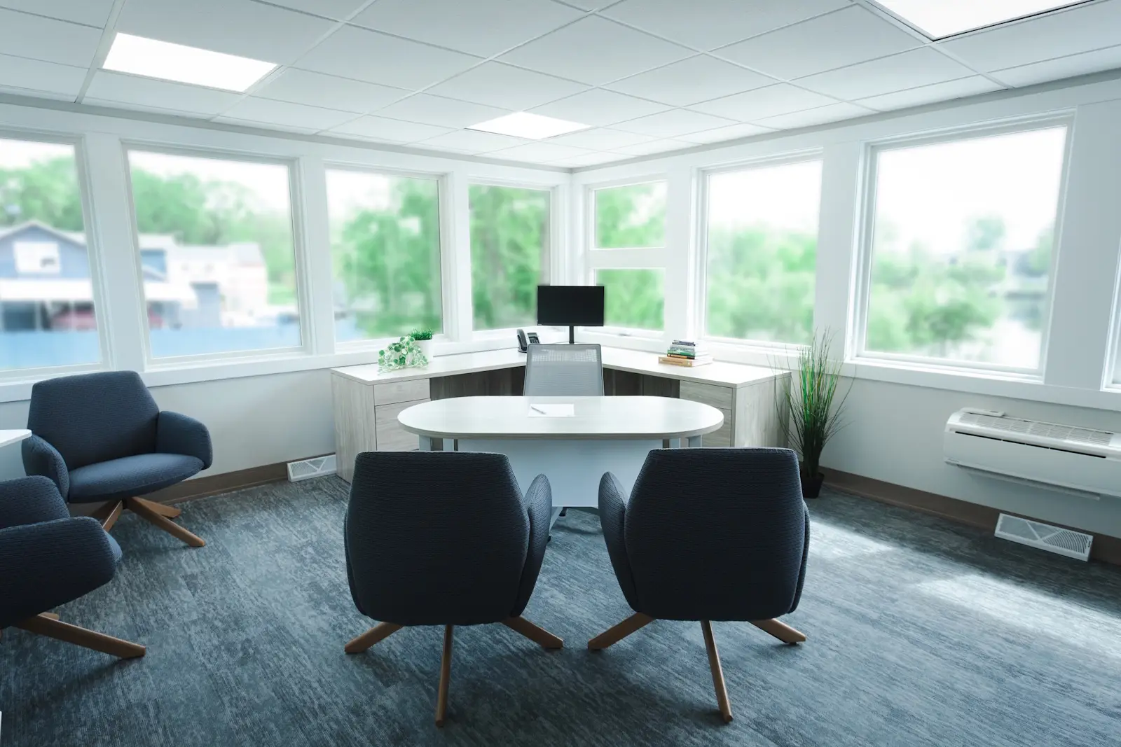 Office seating display inside the Holland, MI showroom, showing a variety of chairs arranged on white platforms.