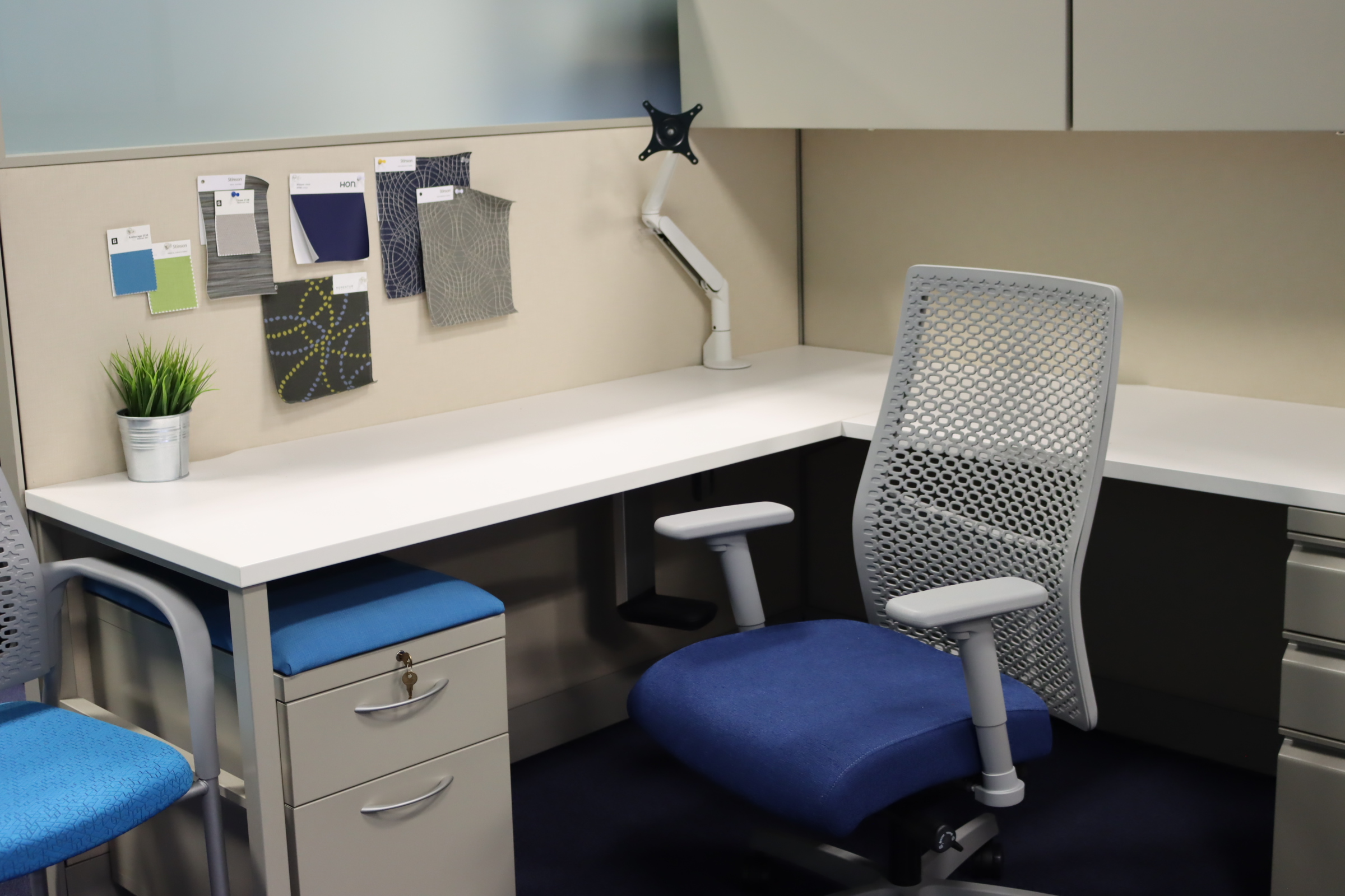 Private office workstation display in the Kalamazoo showroom with wood desk, storage cabinets, and ergonomic chair