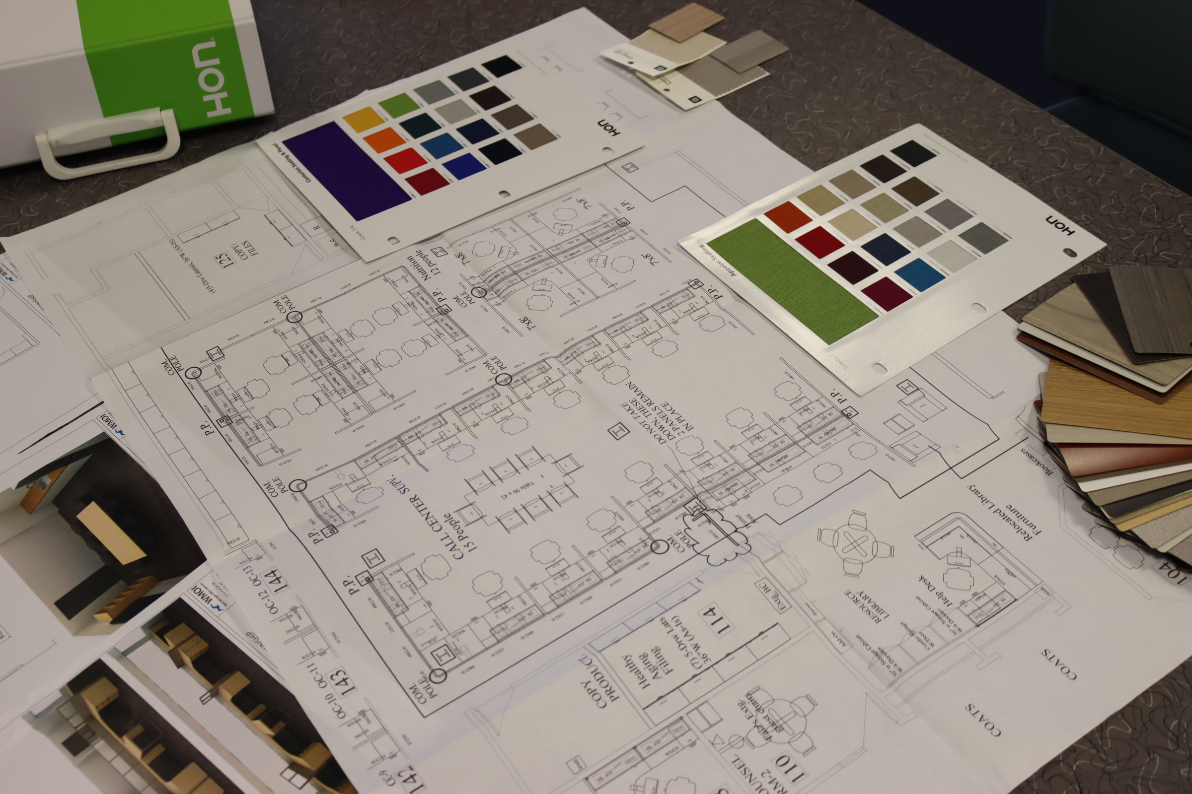 Space planning layouts with floor plans, furniture selections, and finish samples.