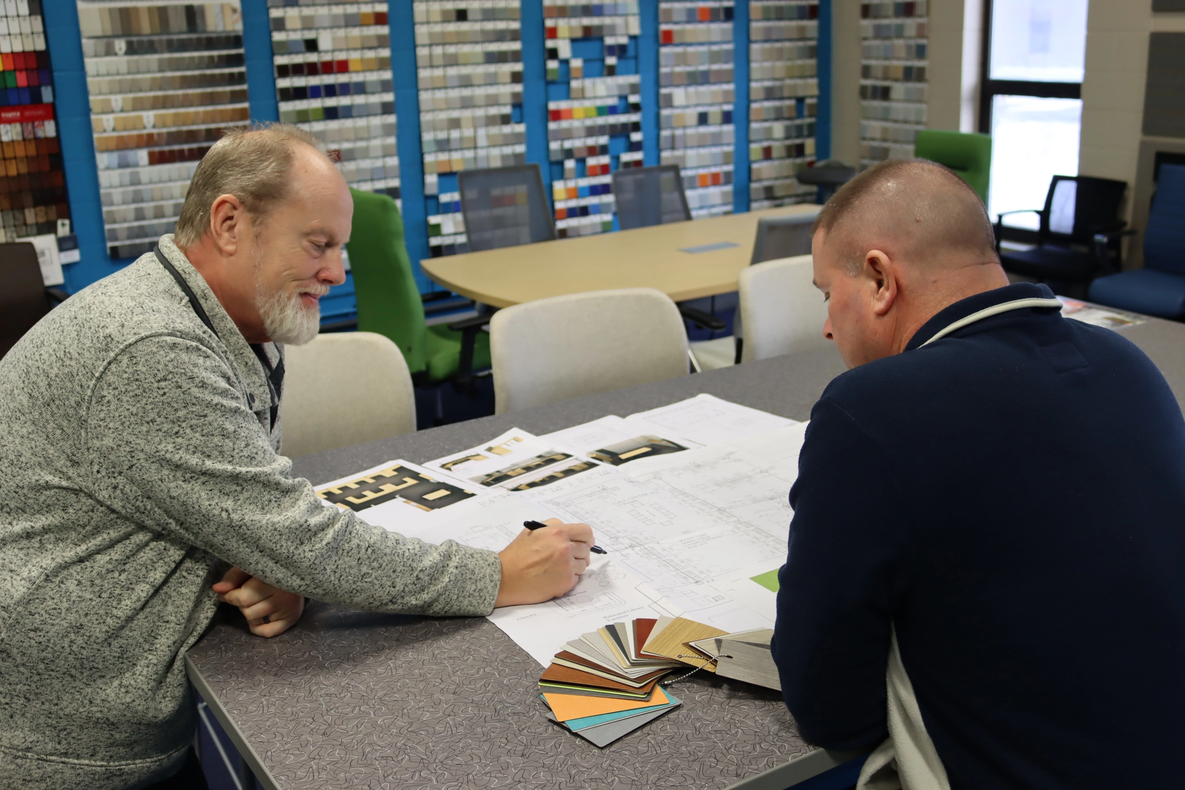 office furniture consultation reviewing workspace design plans