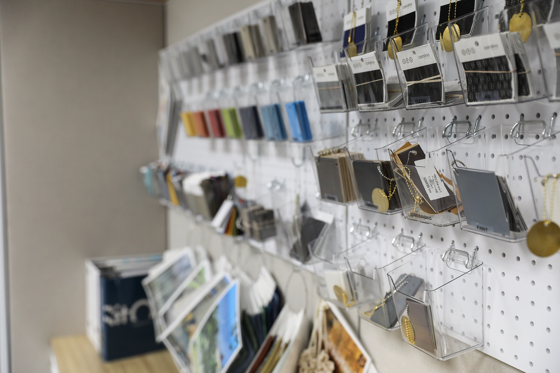 Wall-mounted display of material and finish samples inside the Holland, Michigan showroom.