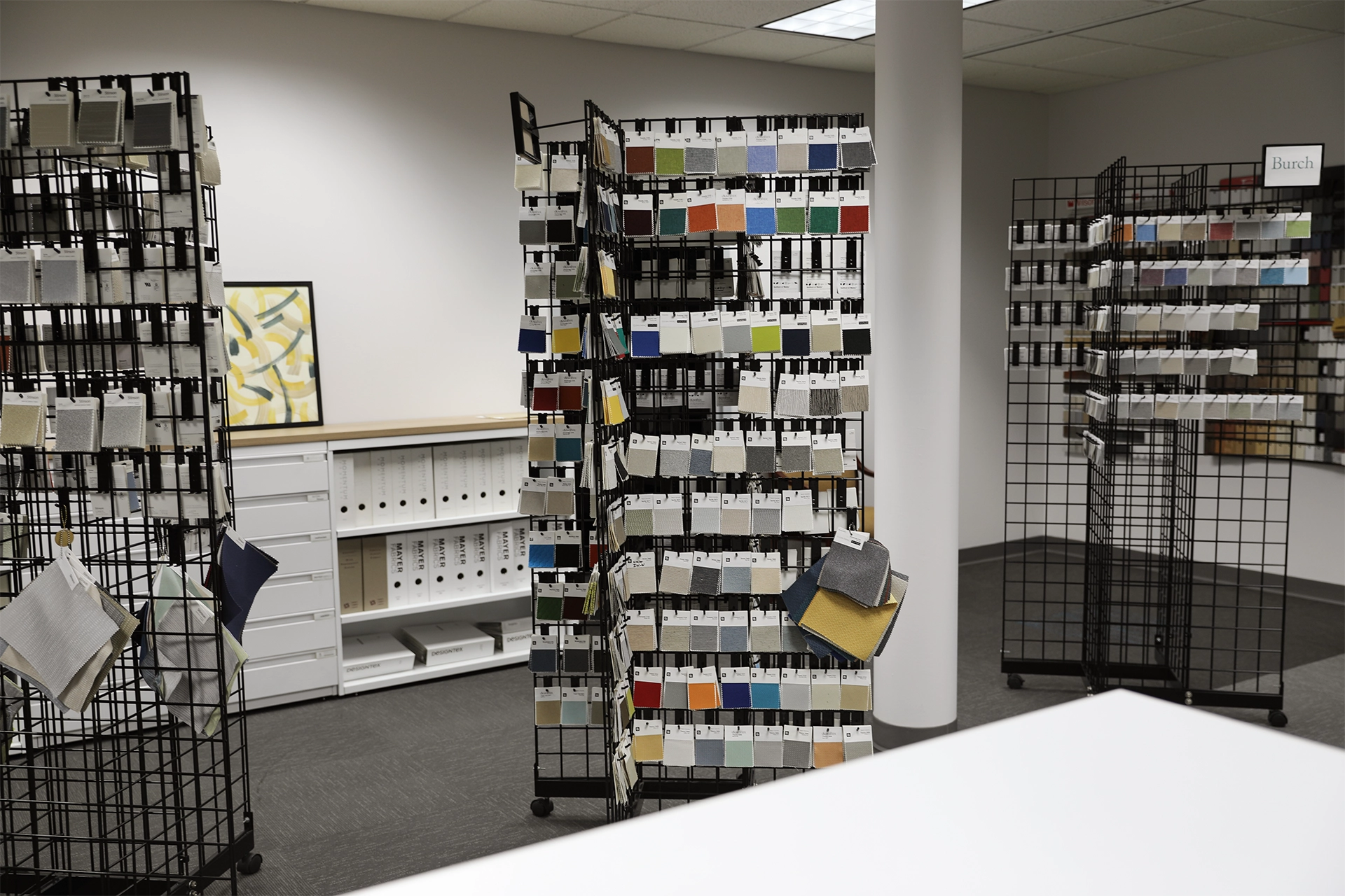Fabric and upholstery sample racks inside the Holland, Michigan showroom, organized for browsing and comparison