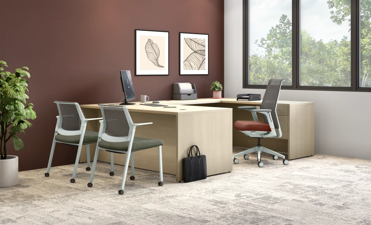 10500 Series executive desk with return in light laminate, guest chairs and mobile pedestal in private office
