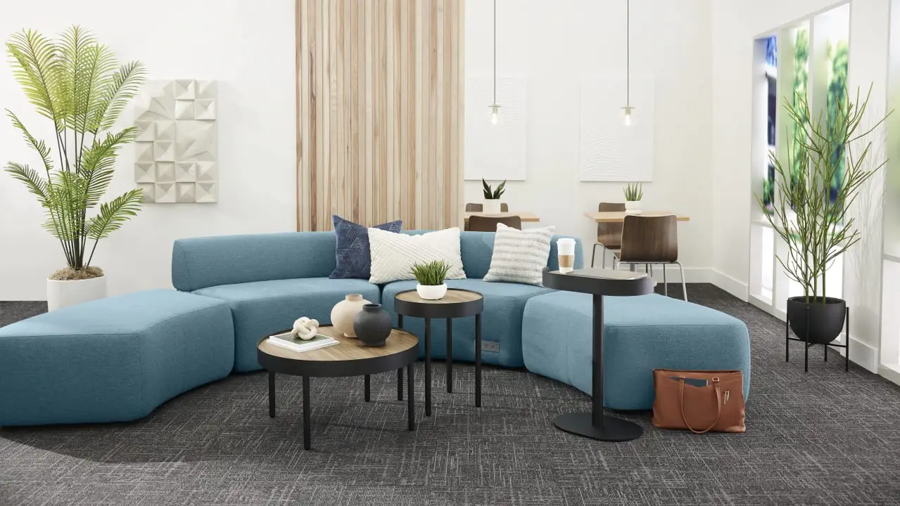 HON Sculpt occasional tables throughout a lounge with curved blue modular seating.