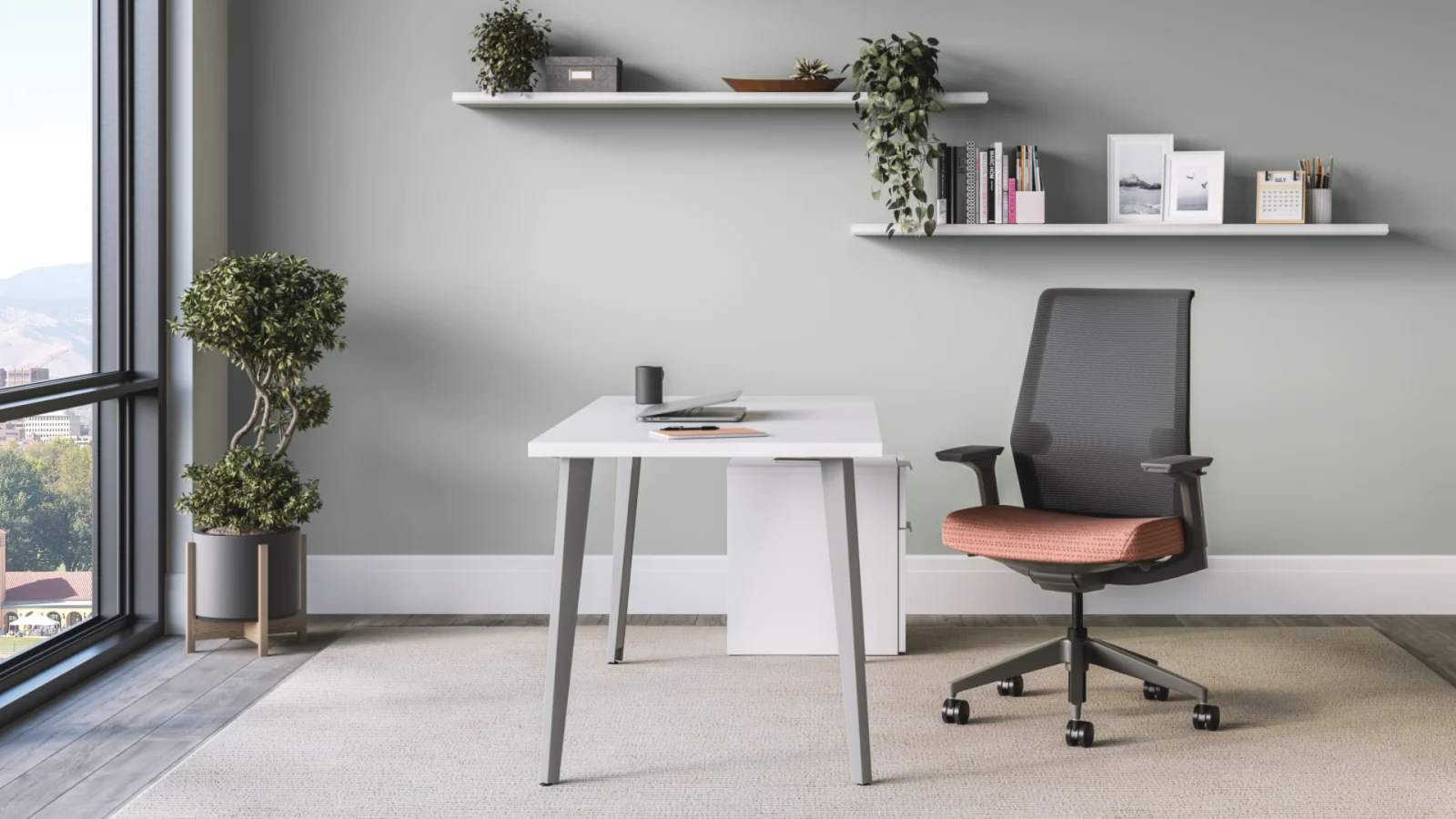 HON Voi white laminate desk with angled legs in a private office, shown with a mesh back task chair and wall shelving.