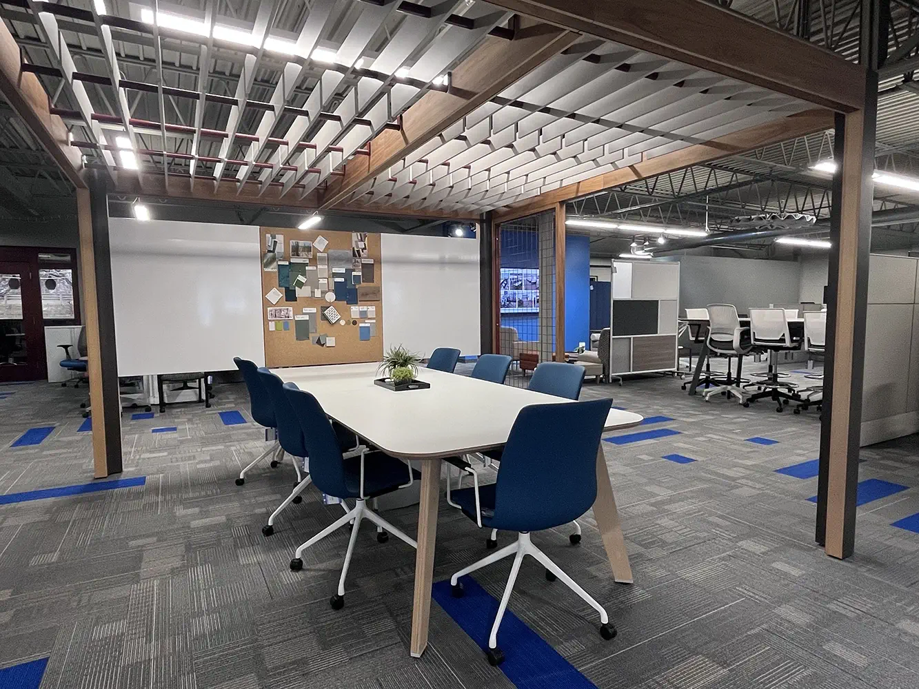 Grand Rapids office furniture showroom with modern cubicles, blue accent walls, and open workstations