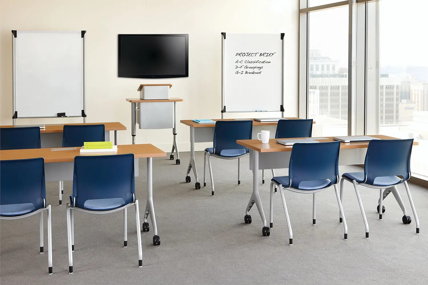HON Motivate tables and seating in a modern training room setup.