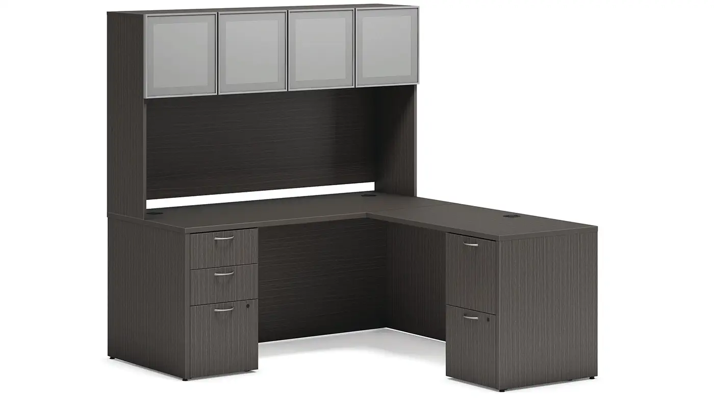 HON Mod L-shaped office desk with overhead storage cabinets and drawers in dark wood laminate.