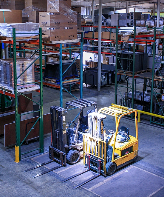 Office furniture staged and organized in a warehouse for delivery
