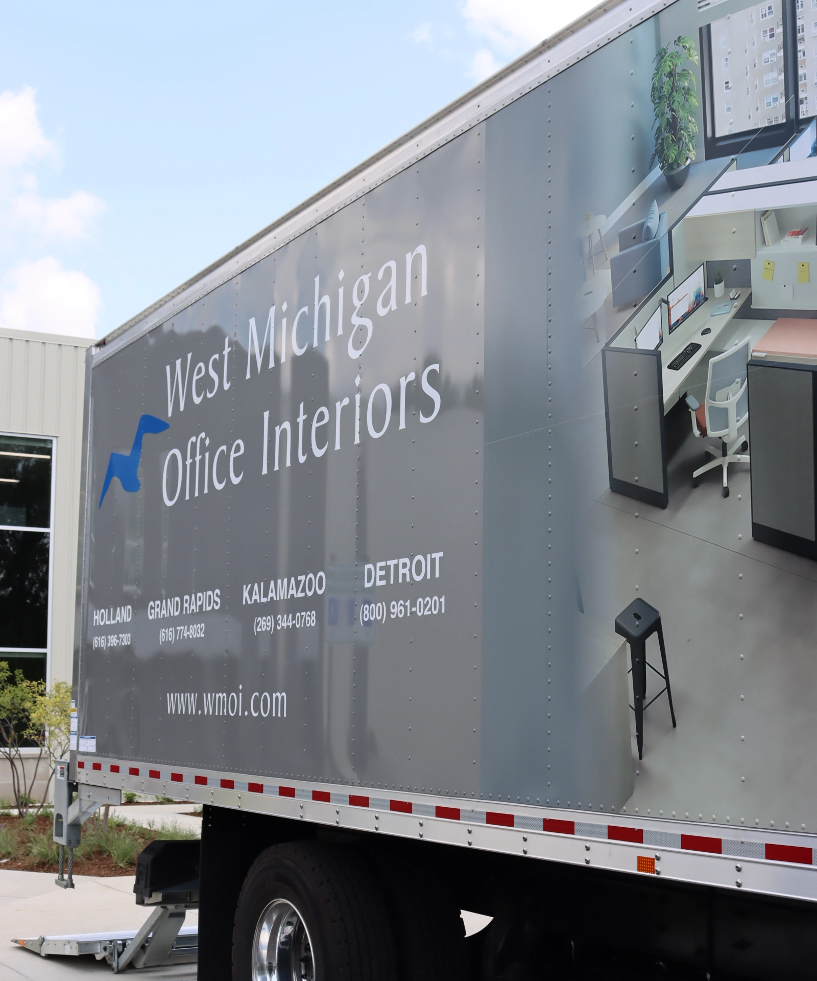 West Michigan Office Interiors delivery truck transporting office furniture for commercial installation.