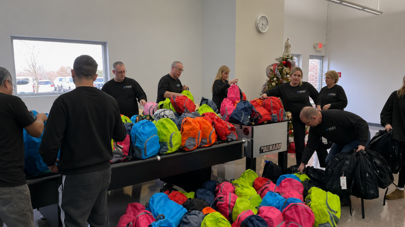 Picture of WMOI employees packing bags for Hope Packages donation